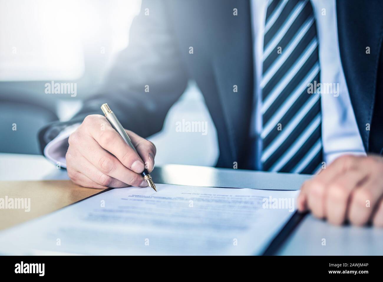 Business man signing contract document on office desk, making a deal. Stock Photo