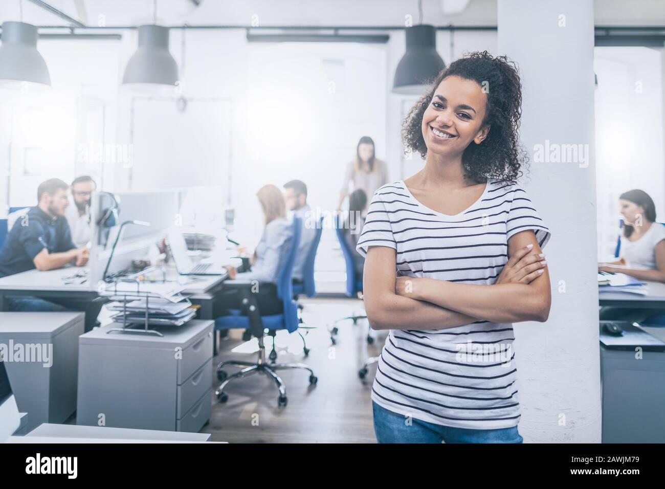 Portrait of young confident woman leader standing in office. New start up business concept. Stock Photo
