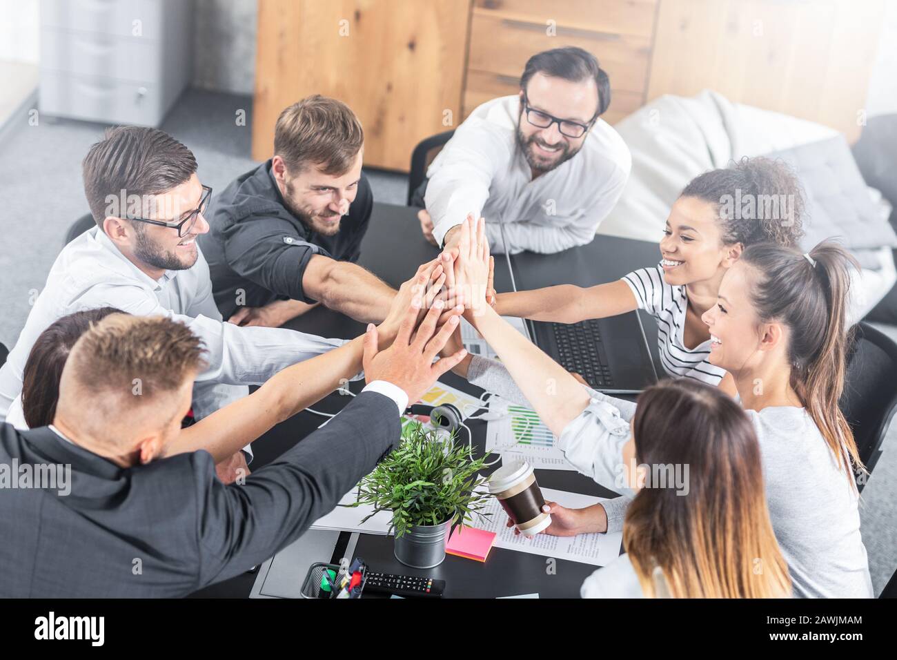 Business people happy showing team work and giving five in office. Teamwork concepts. Stock Photo