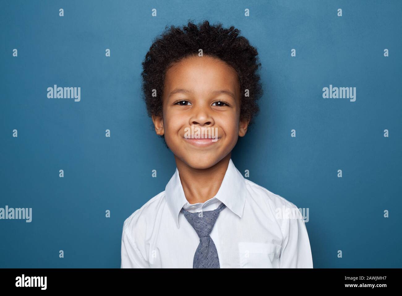 Portrait of black kid boy pupil on blue background. Happy child student school boy Stock Photo