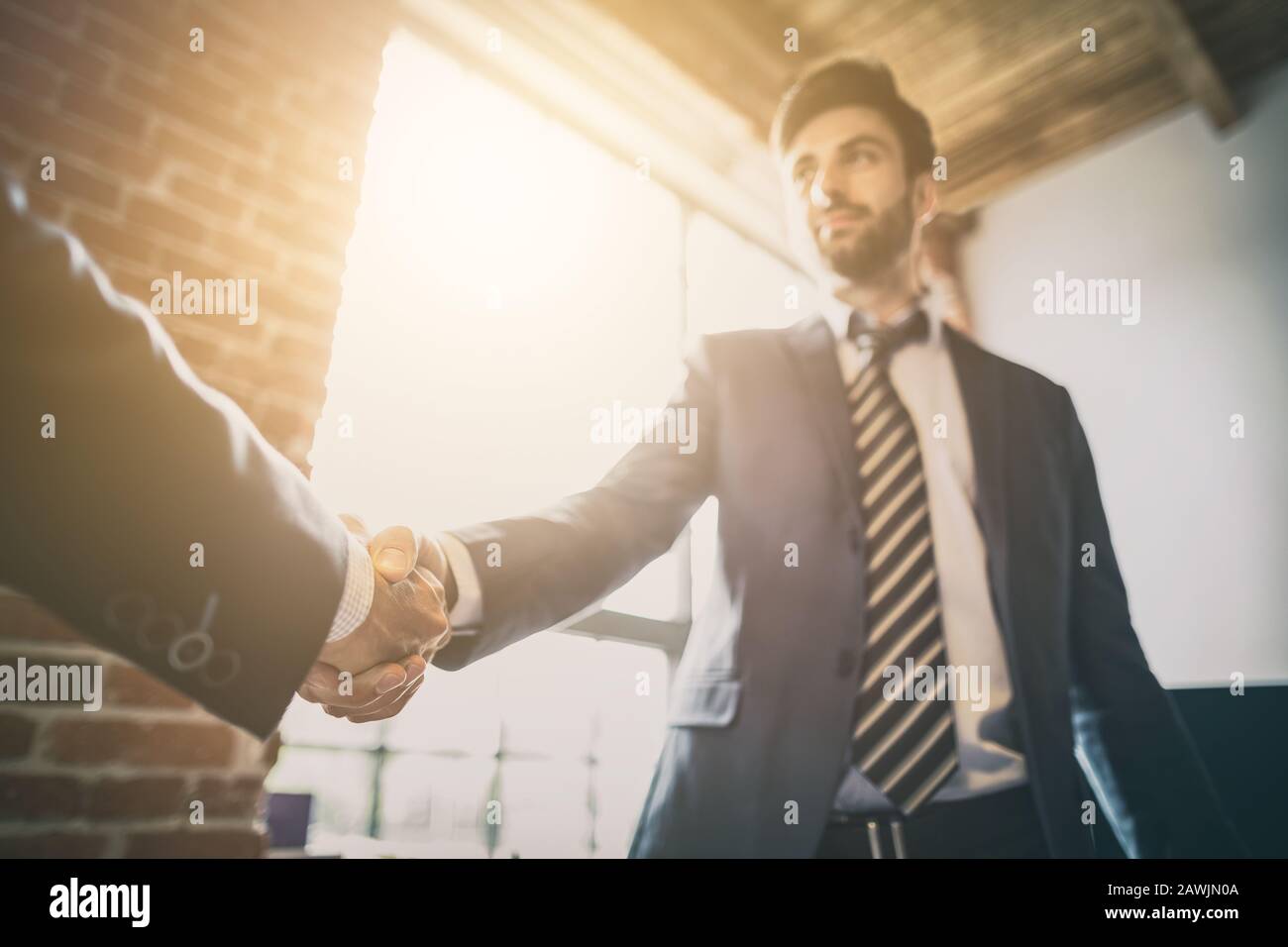 Business people shaking hands, finishing up meeting. Successful businessmen handshaking after good deal. Stock Photo