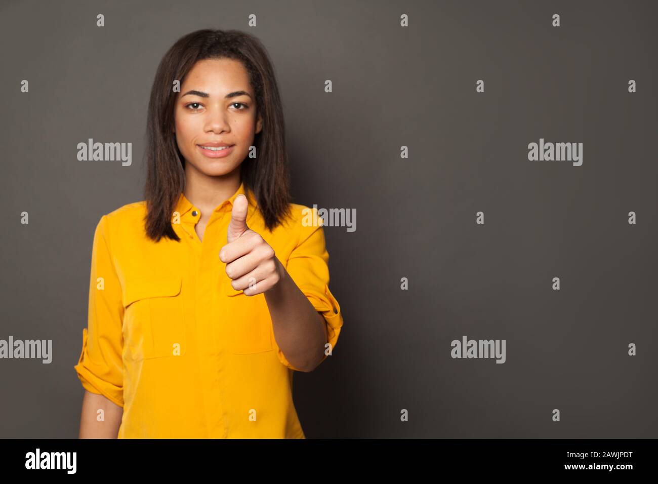 African American woman showing thumb up on gray background Stock Photo ...