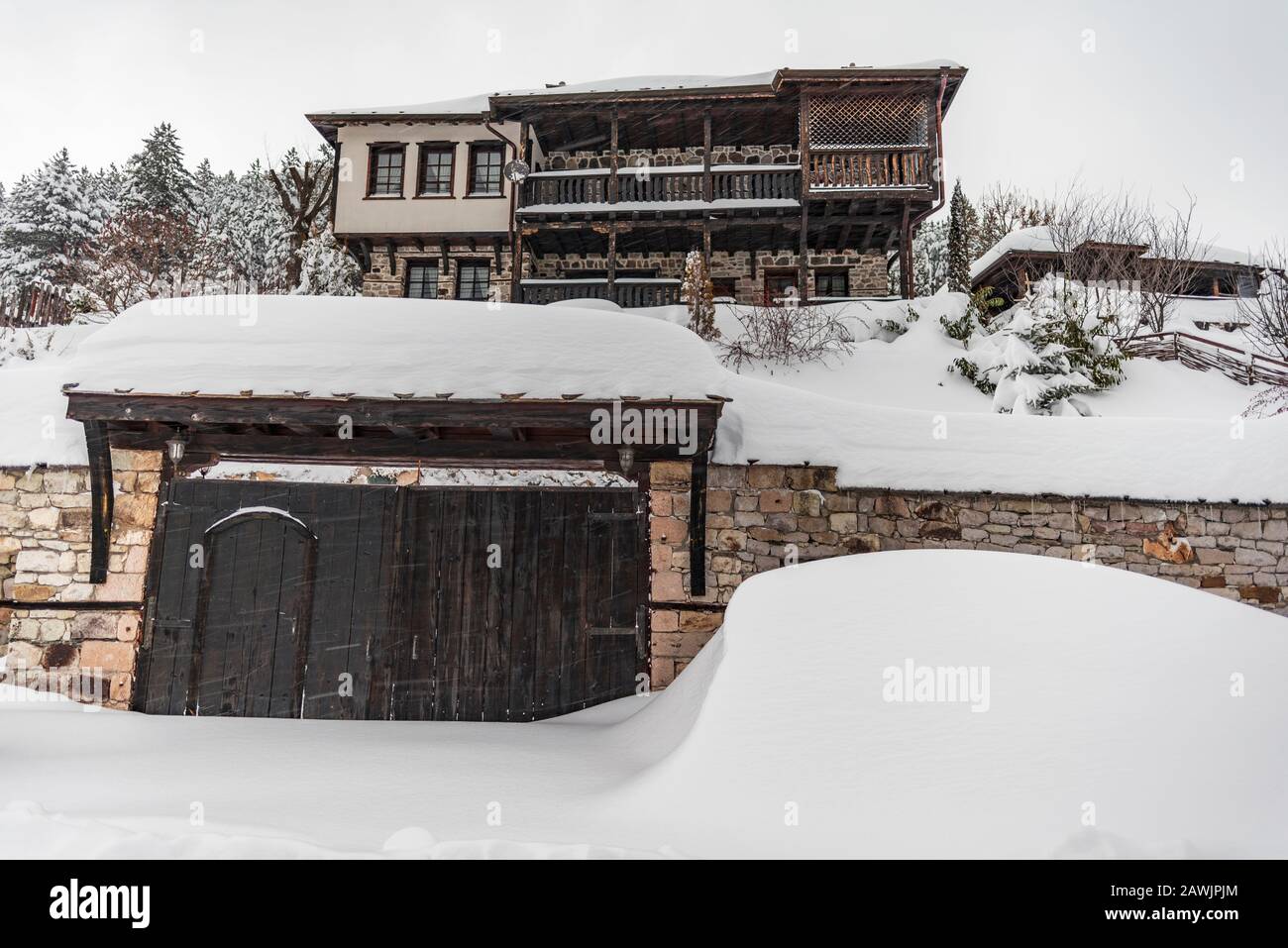 Mountain house built of wood in Rhodope Mountains in winter season, Bulgaria Stock Photo