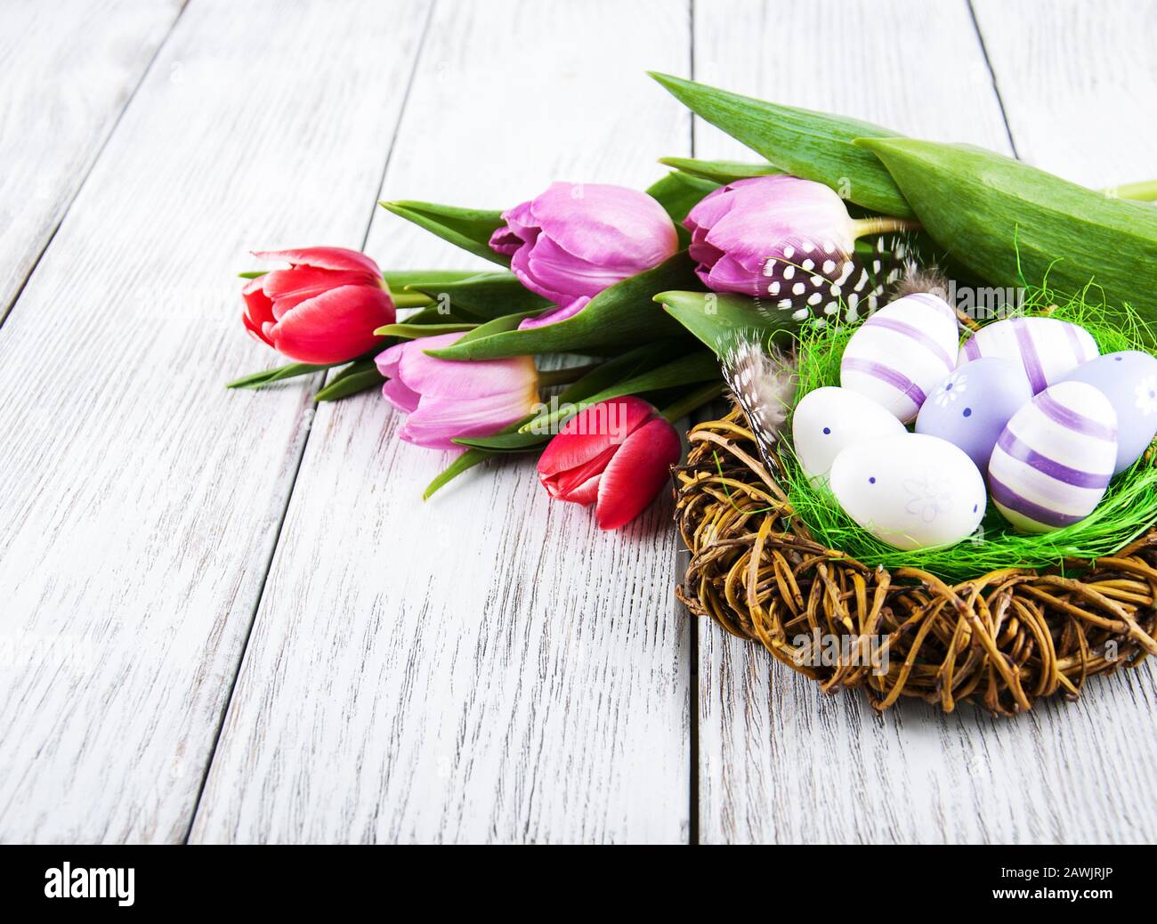 easter decoration with eggs in nest and pink tulips Stock Photo - Alamy