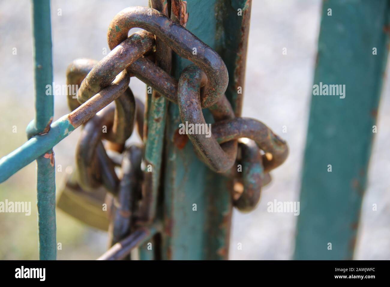 The chain with a padlock locks the rusty metal gate Stock Photo - Alamy
