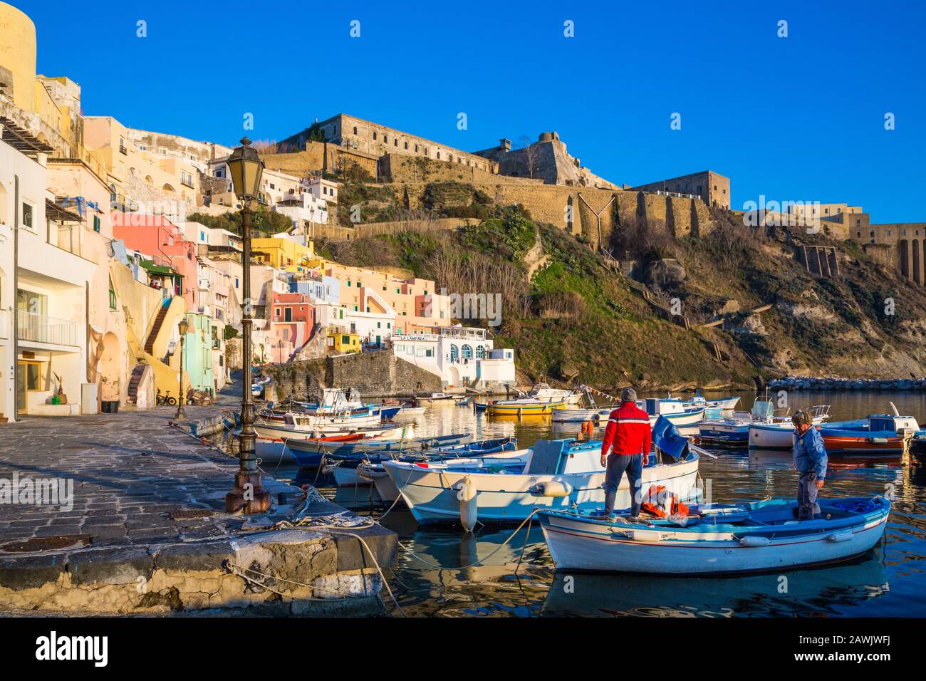 PROCIDA, ITALY - JANUARY 3, 2020 - View of Corricella bay in the sunset light, a romantic village of fishermen in Procida, Italy Stock Photo