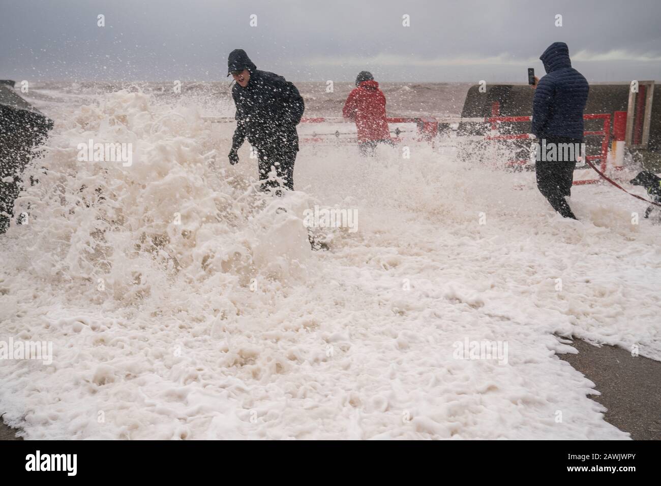 New Brighton, Wirral. 9th Feb, 2020. People are soaked by waves crashing into the promenade at New Brighton on the Wirral caused by Storm Ciara. Credit: Christopher Middleton/Alamy Live News Stock Photo