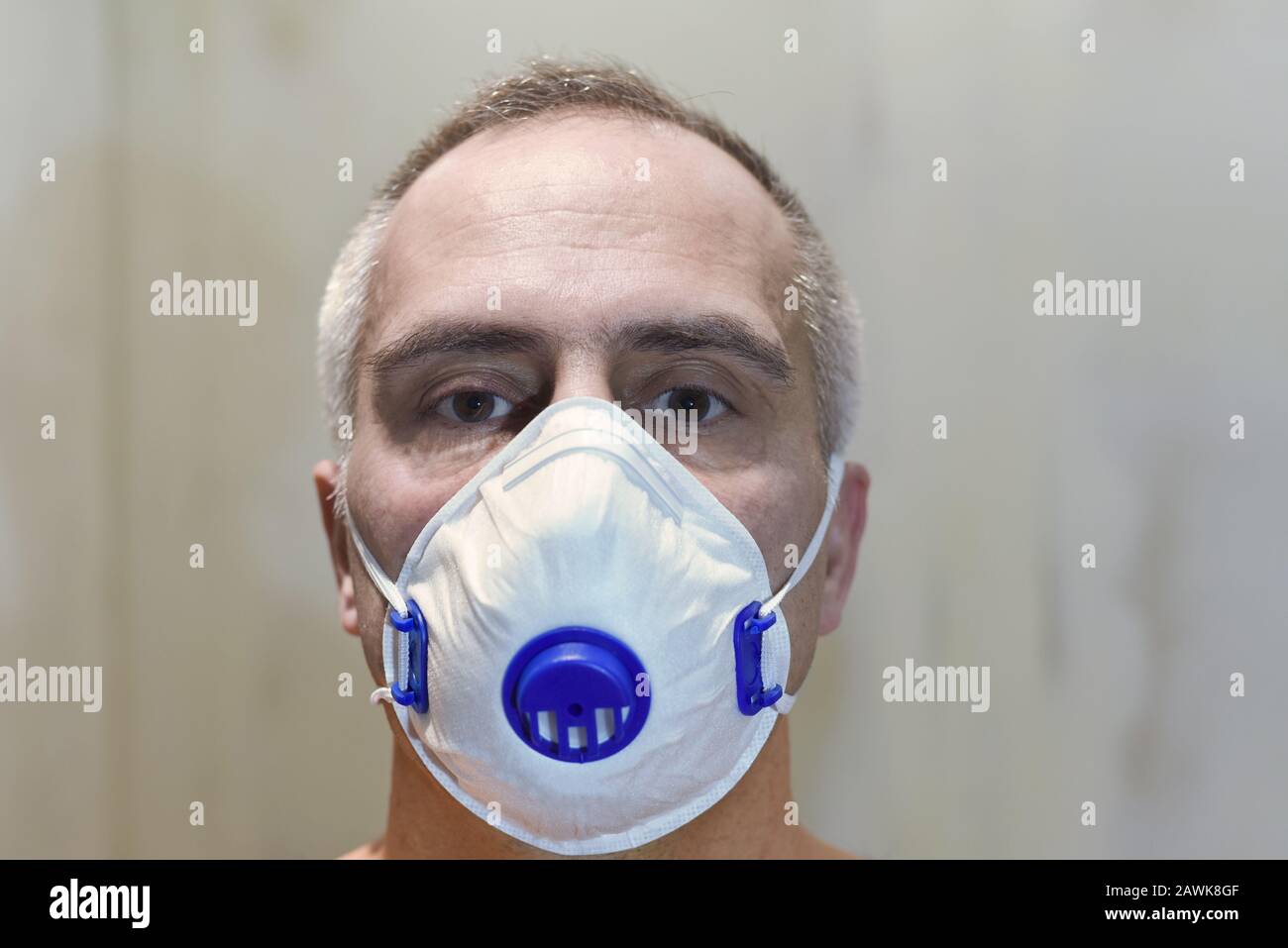 man face with protective medical mask, filter respirator,  concept of fine dust pollution, viral infection, outbreak of coronavirus, epidemic, healthc Stock Photo