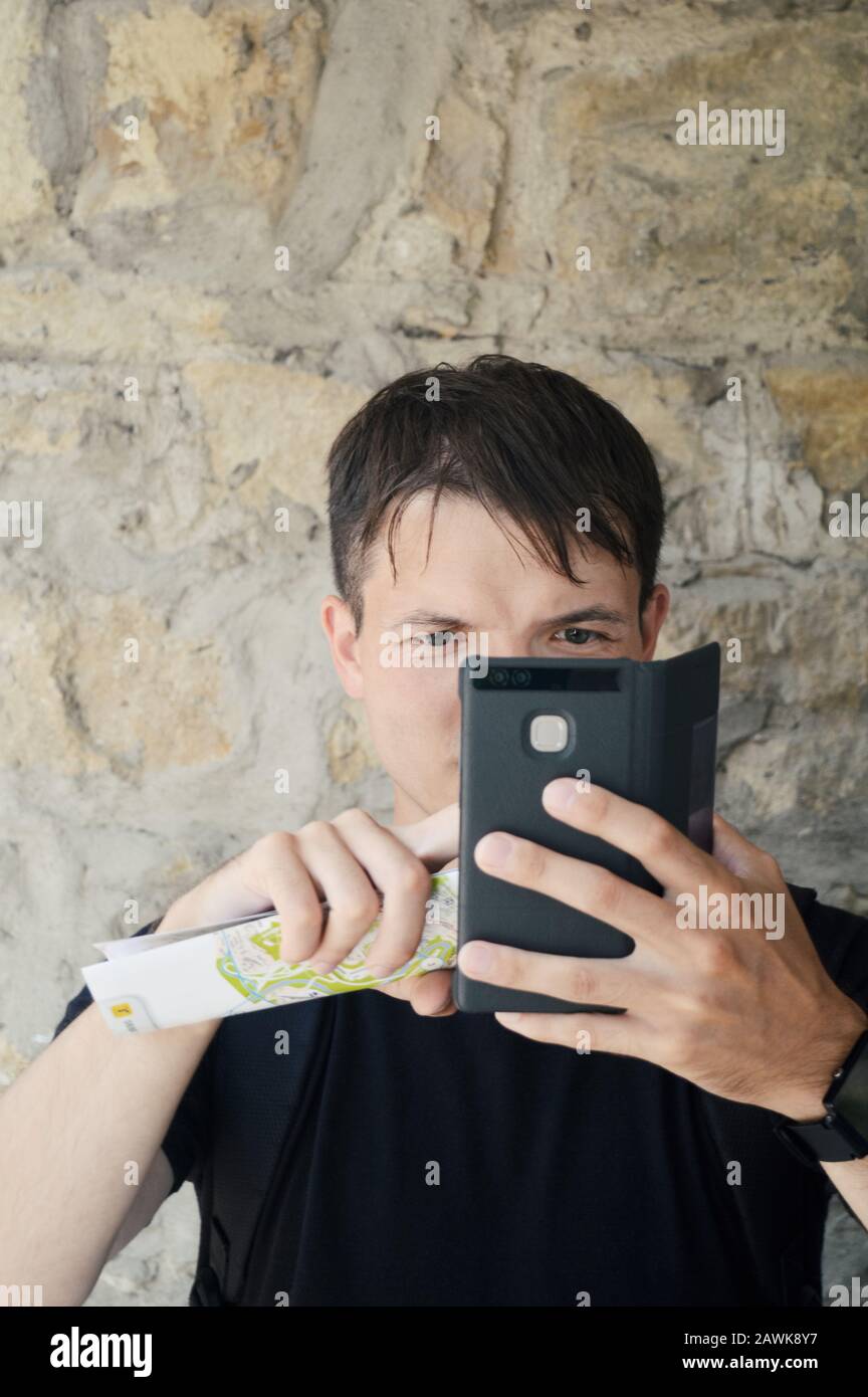 young man, a traveller with smartphone use modern mobile internet technology to find the right way, cellular network broadband coverage concept Stock Photo