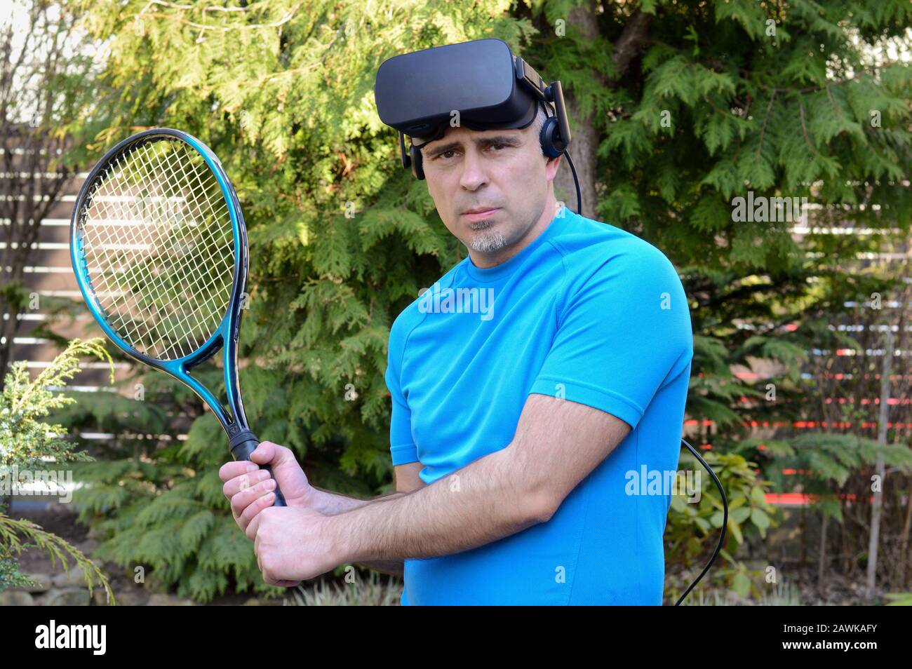 man with virtual reality headset and tennis racket before a game and ready  experience the computer-generated simulation on a summer day Stock Photo -  Alamy