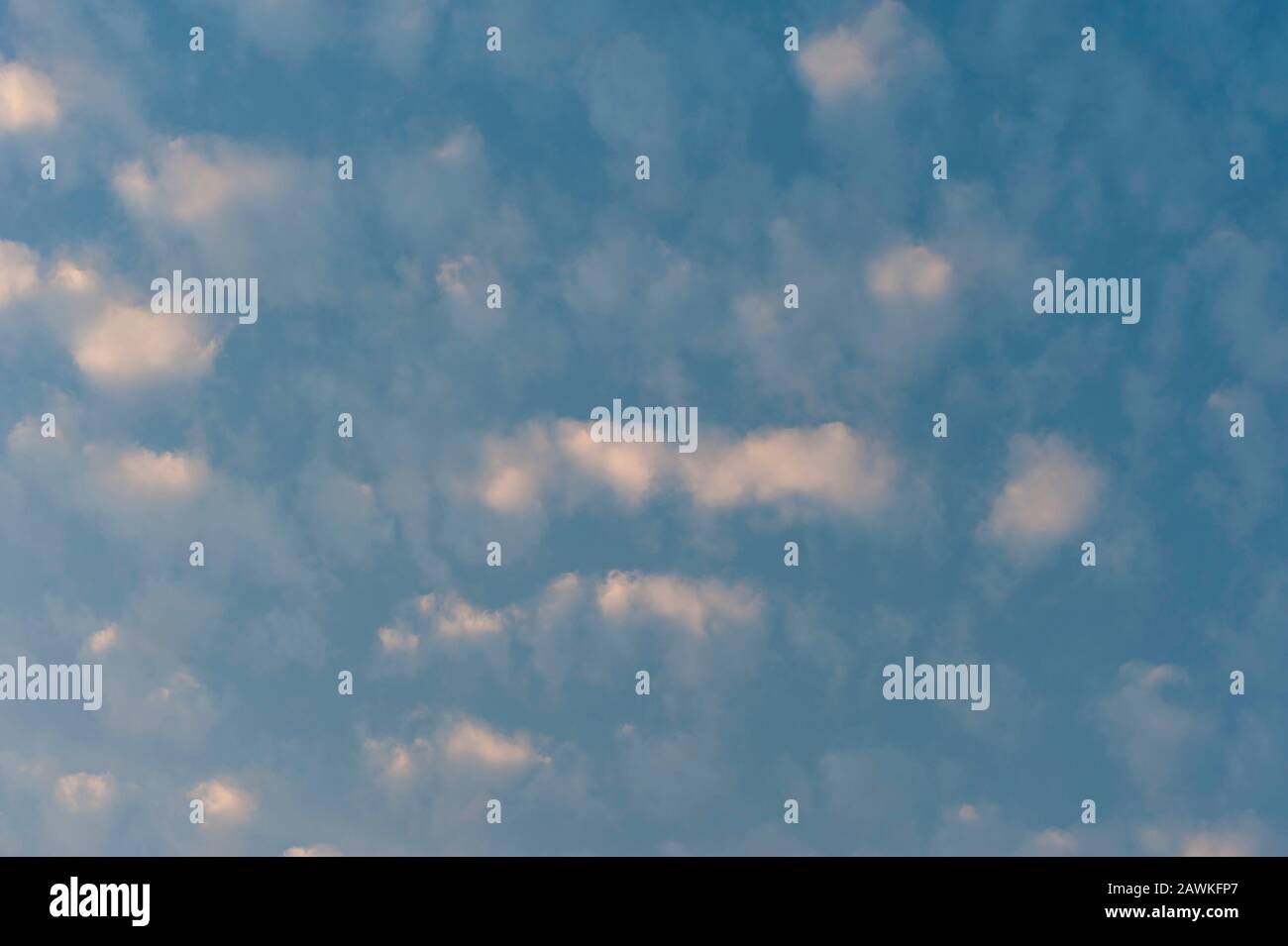 Cumulus sunset clouds with sun setting down Stock Photo - Alamy