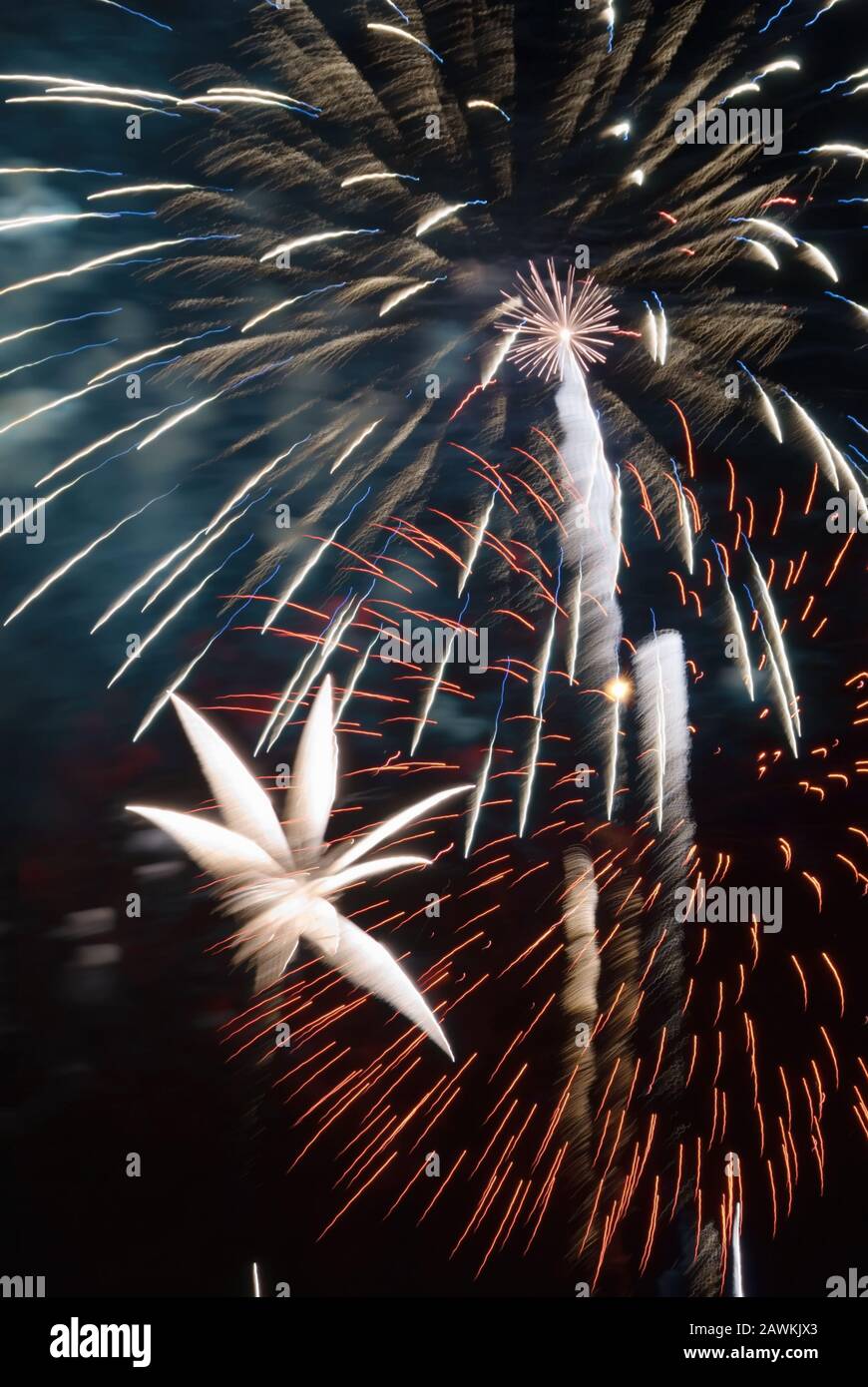 Firework display explosion creates a colorful contrast of color and blurred motion against a darkened night sky. Awe was the most used word that eveni Stock Photo