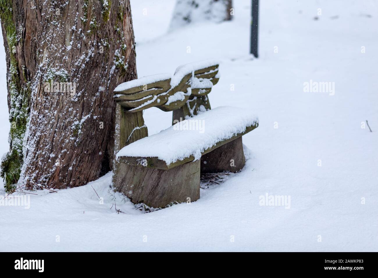 Bench covered with snow in the park Stock Photo - Alamy