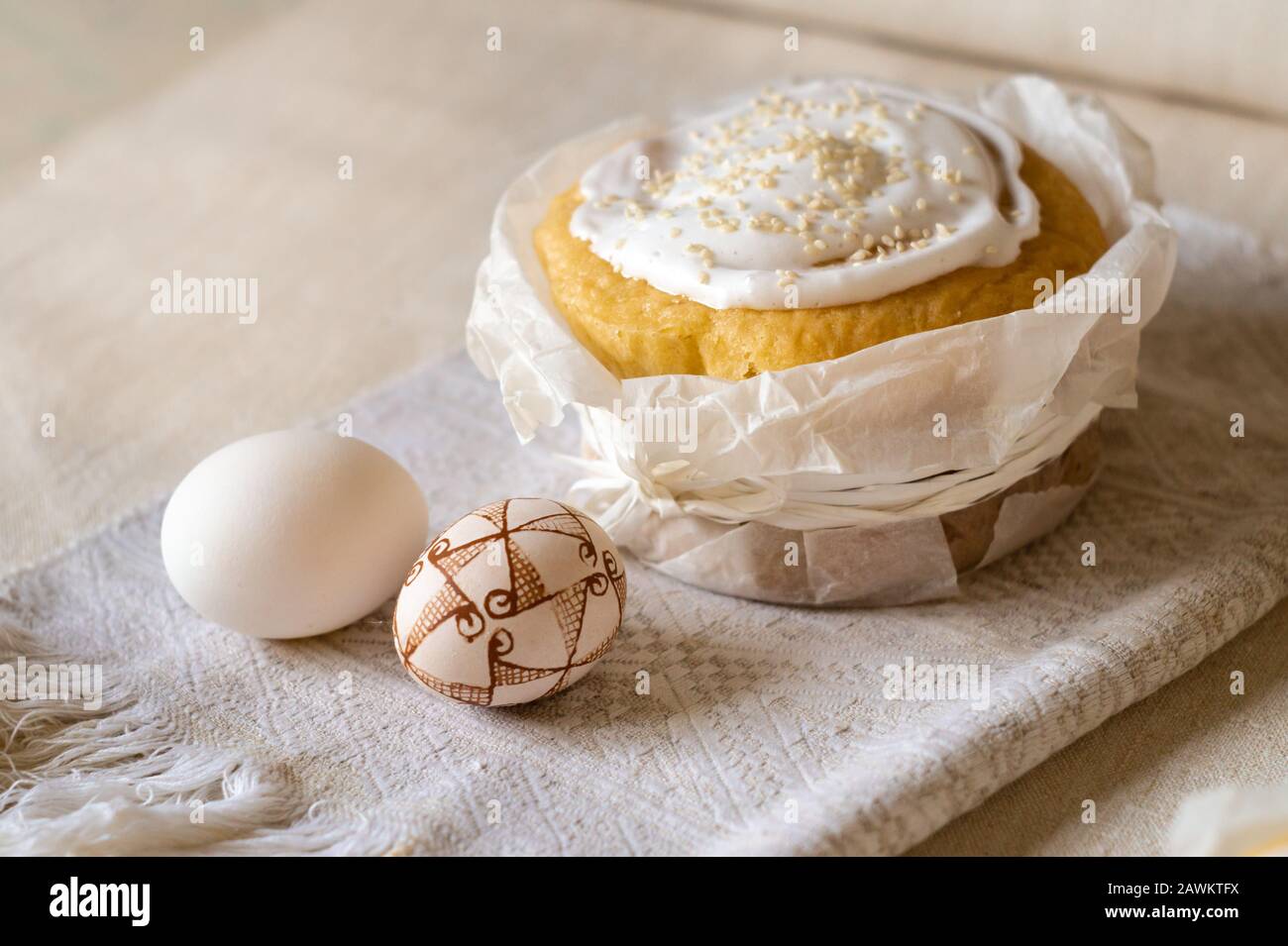 Traditional easter cake and decorated easter eggs on a linen tablecloth