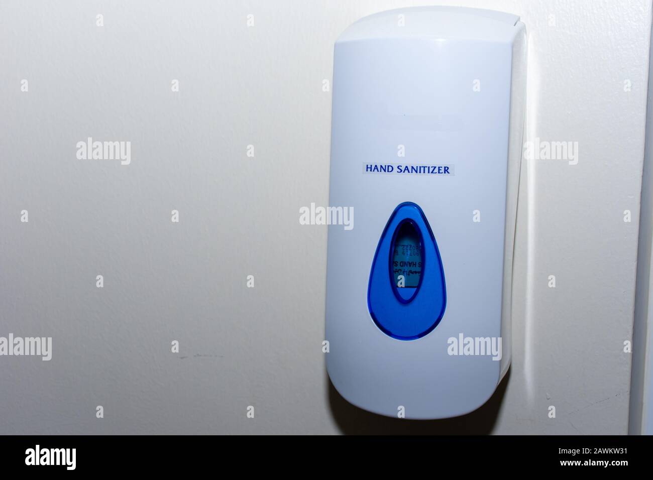 Hand sanitizer dispenser on a wall to protect against illness, bacteria