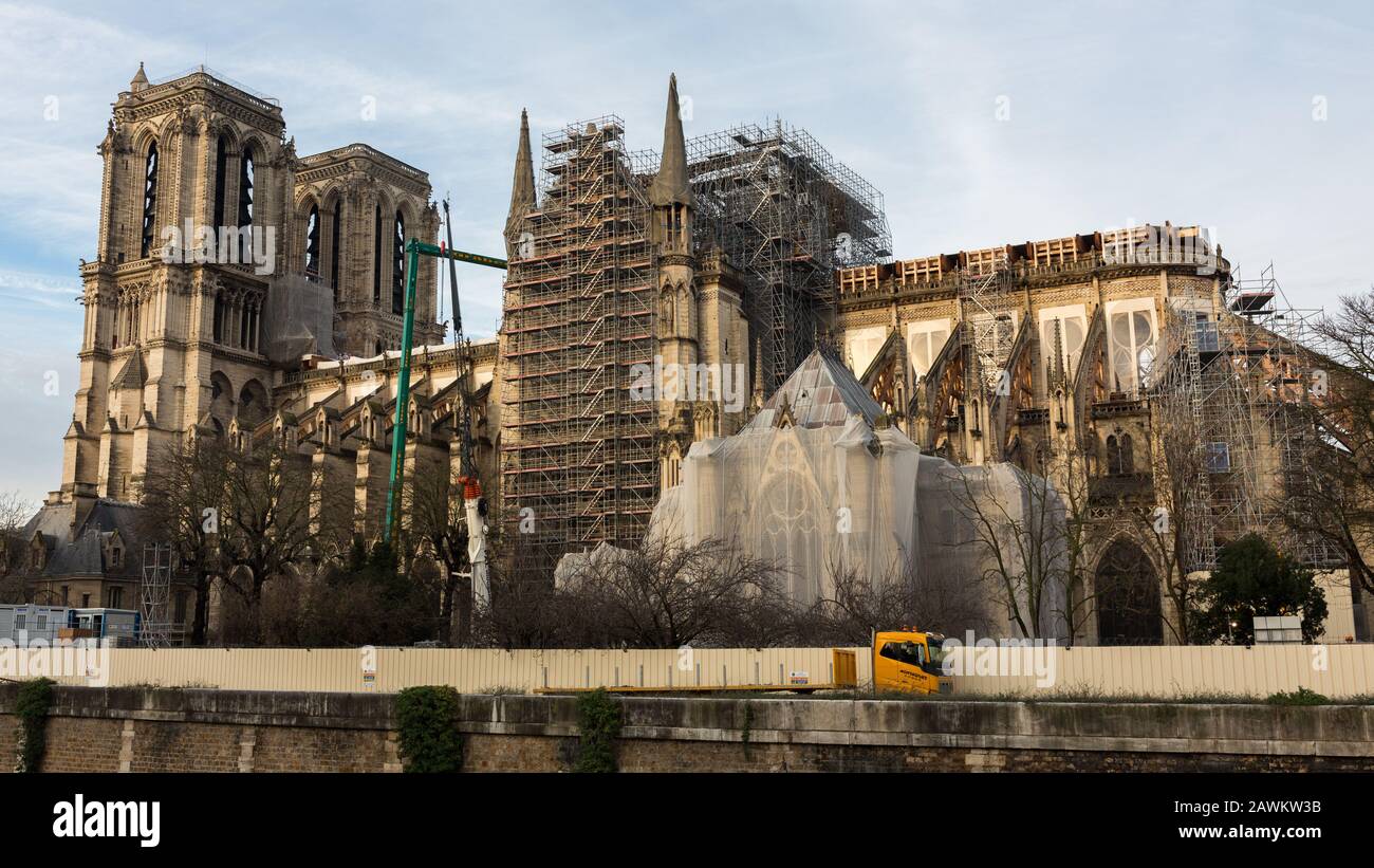 Side view on Notre Dame. The scaffoling along the side wall is new. The one in the middle partially melted during the fire of April 19, 2019. Stock Photo