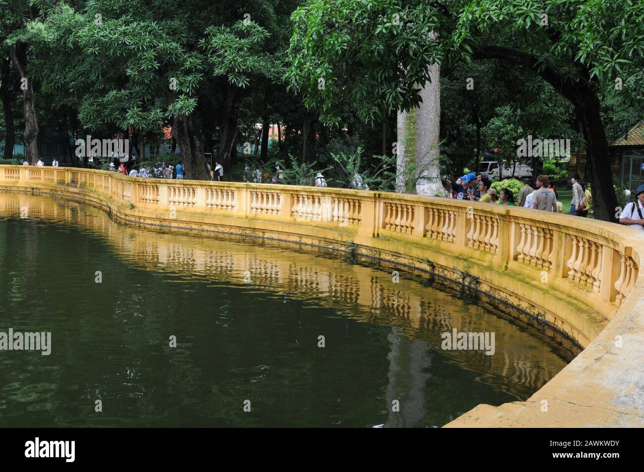 Hanoi, Vietnam, August 3 2010:  People walking near a lake at the Presidential palace gardens at Hanoi city in Vietnam Asia Stock Photo