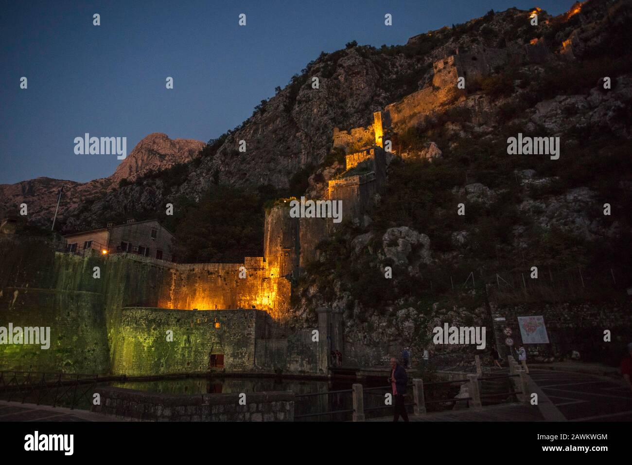 Night view of Kotor city walls, Our Lady of Remedy catholic church and St John fortress.  Old town Kotor. Montenegro Stock Photo