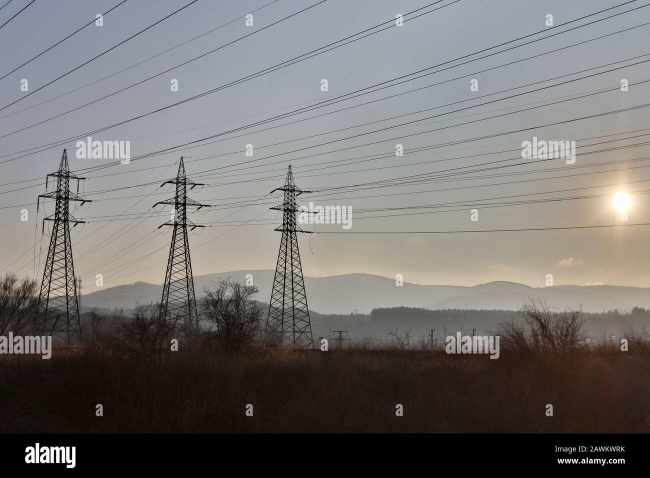 High voltage electric pole and transmission lines in the evening ...