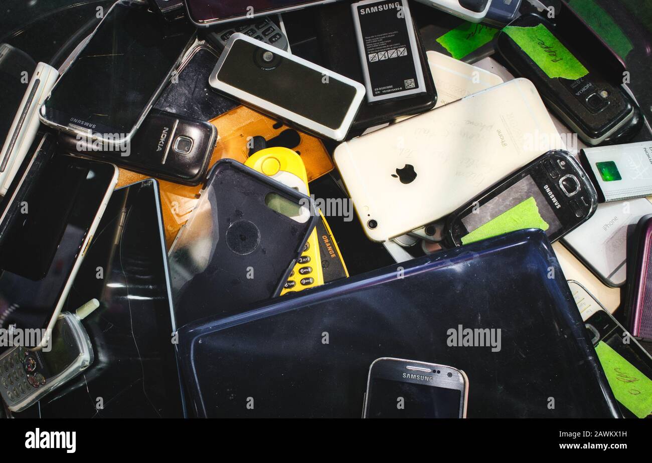 Mosta / Malta - May 11, 2019: Broken mobile digital devices in a bin to be recycled Stock Photo
