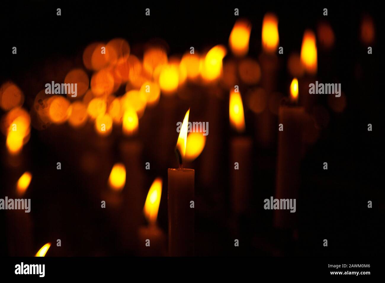 candles with lights on the dark background Stock Photo - Alamy