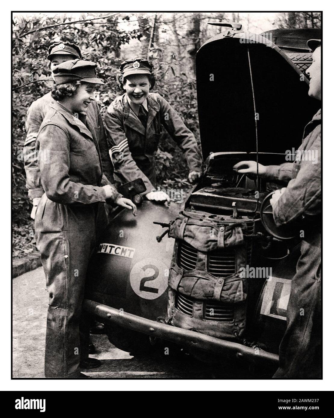 Princess Elizabeth ATS 1940's World War II Car Mechanic. HRH Princess Elizabeth (future Queen Elizabeth II) in her uniform of the ATS The Auxiliary Territorial Service a women’s army auxiliary branch, with other smiling ATS service members working on and servicing a British Army military vehicle. Stock Photo