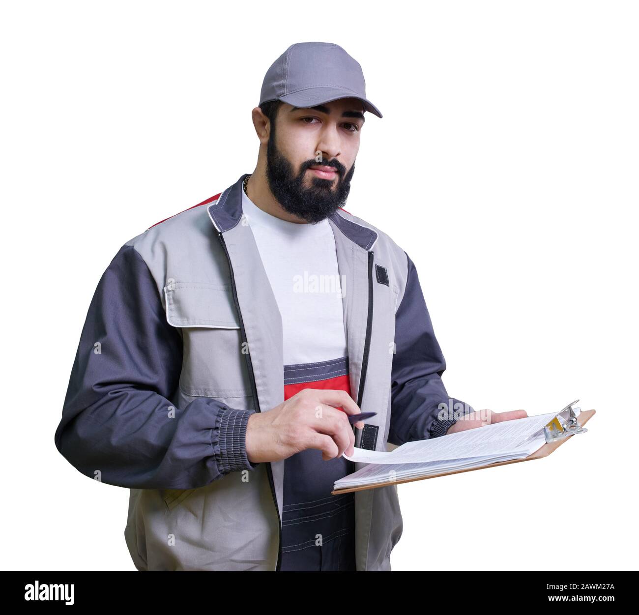Concentrated young technician wearing overall standing and taking some notes Stock Photo