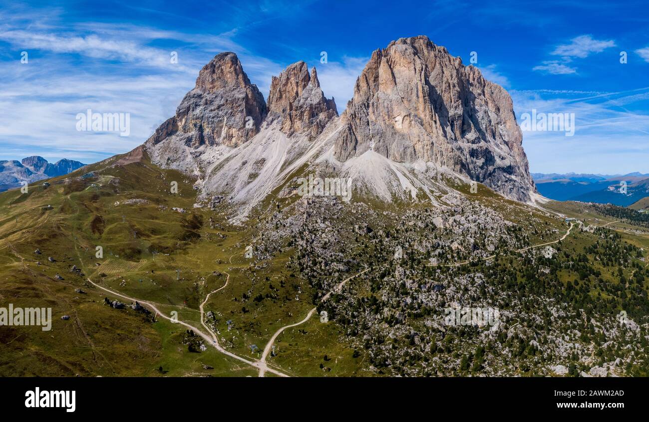 Aerial panorama of Langkofel Group, Grohmannspitze mountain, Fuenffingerspitze mountain and Langkofel Mountain in Italy Stock Photo