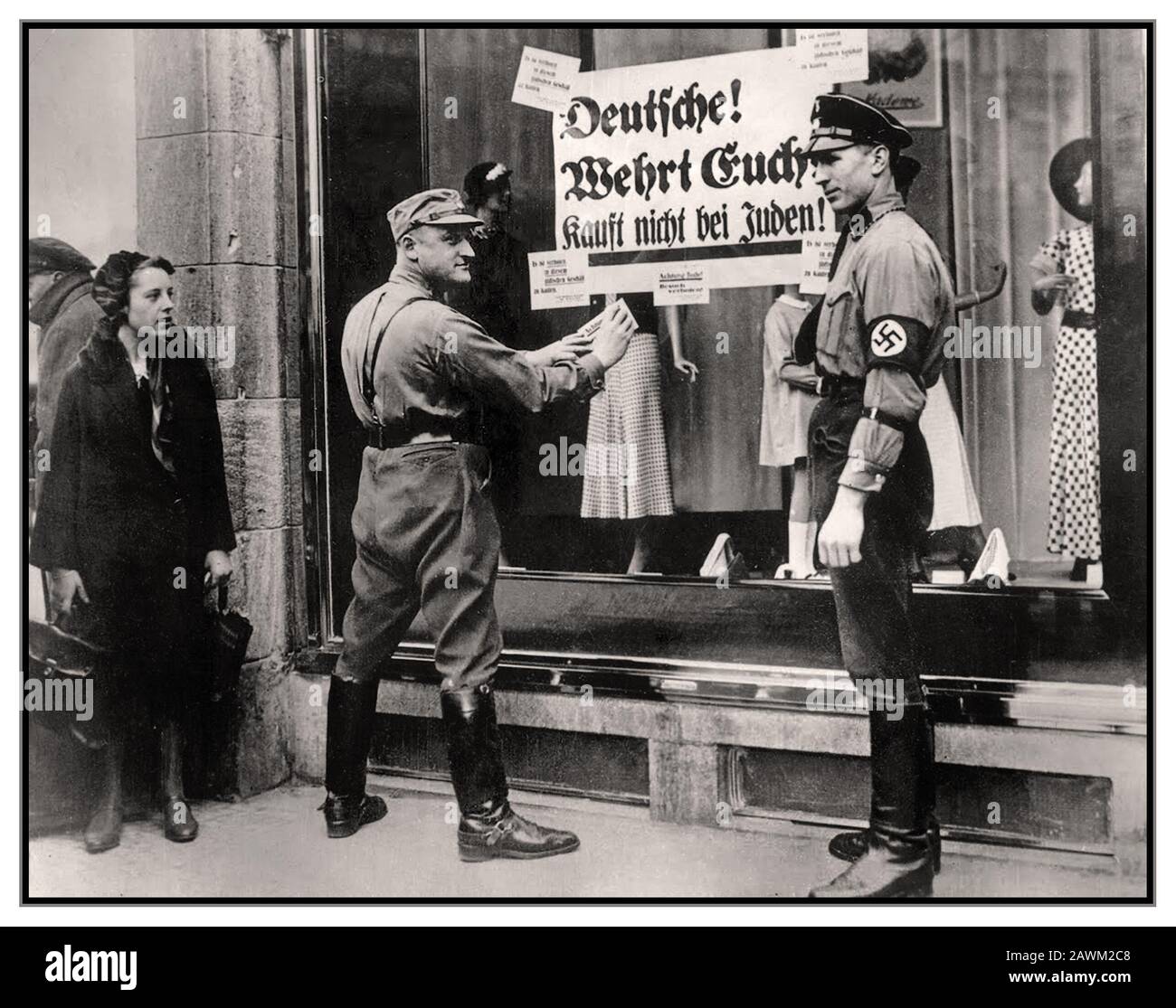 Anti Jewish boycott 1930s Germany Nazi slogans April 1st 1933 produced by German SA paramilitary groups - who stood outside Jewish shops, law firms and doctors' offices. The signs brought along by the brownshirts read: 'Germans! Defend yourselves! Don't buy from Jews!' This was actioned by racist Nazi thugs, emboldened by their official uniformed status, enjoying their dominance over the Jewish population.  The Nazi government organised this one-day boycott of all Jewish-owned businesses in Germany, with assistance of Julius Streicher, publisher of anti-Semitic newspaper Der Sturmer. Stock Photo