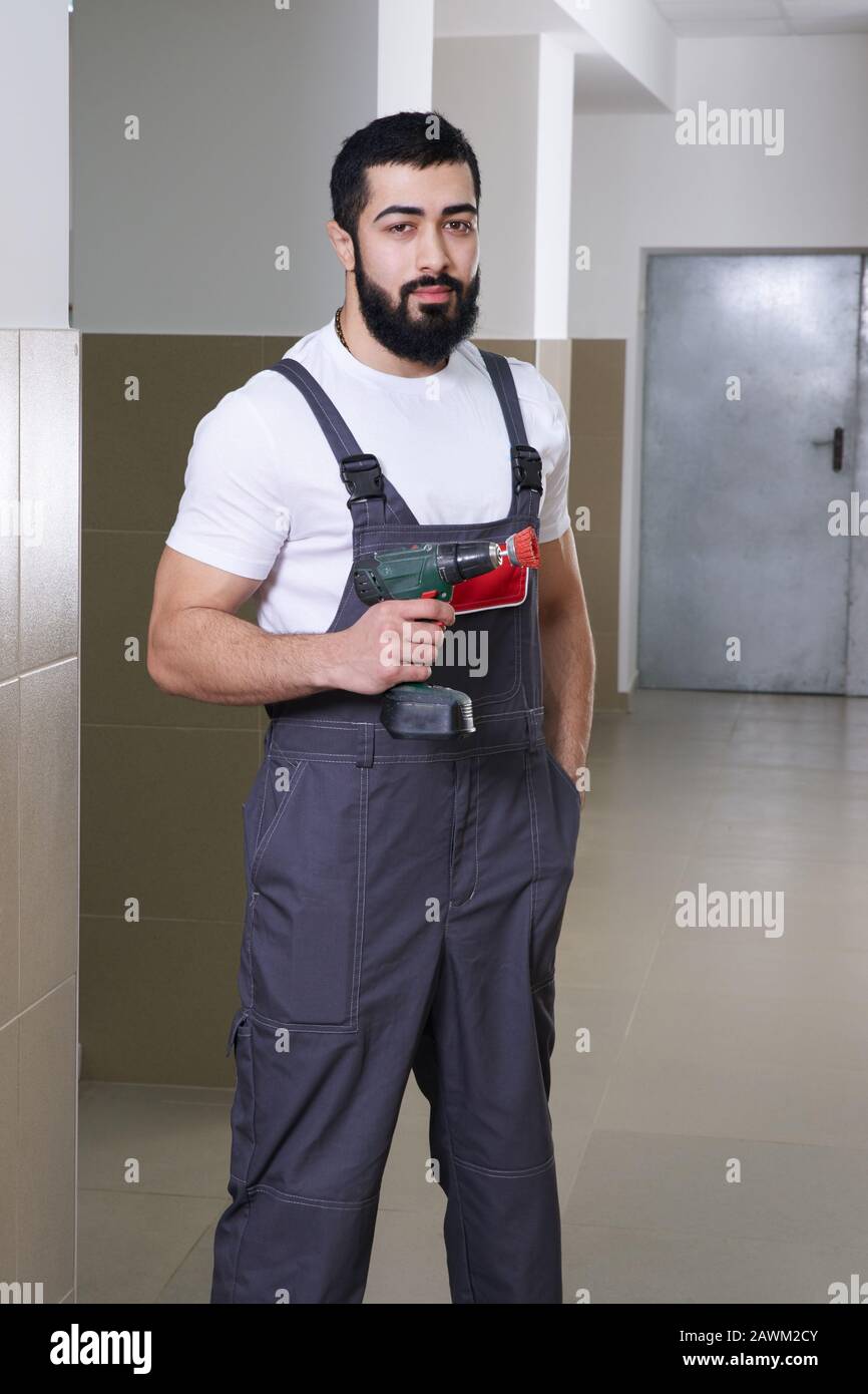smiling worker with red drill Stock Photo