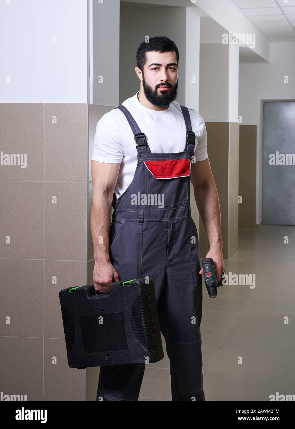 smiling worker with red drill Stock Photo