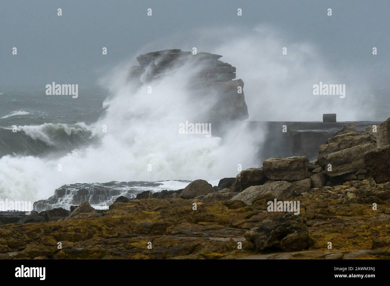 Portland Bill, Dorset, UK.  9th February 2020. UK Weather.  Rough seas whipped up by Storm Ciara smash against Pulpit Rock at Portland Bill in Dorset.  Picture Credit: Graham Hunt/Alamy Live News Stock Photo