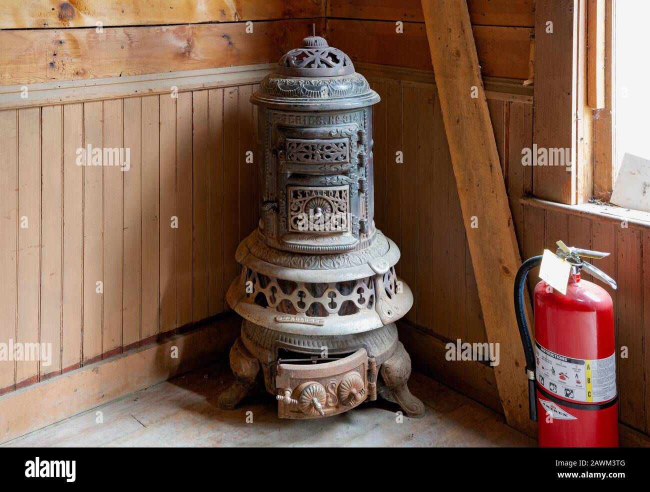 MT00492-00...MONTANA - Fancy wood stove and a modern addition of a fire extinguisher on display at Frank A. Davey's store at the ghost town of Garnet. Stock Photo