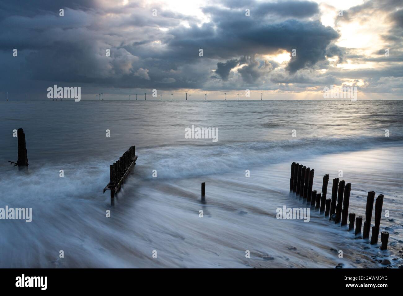 Groynes in the sand at Caistor-on-Sea at sunrise Stock Photo