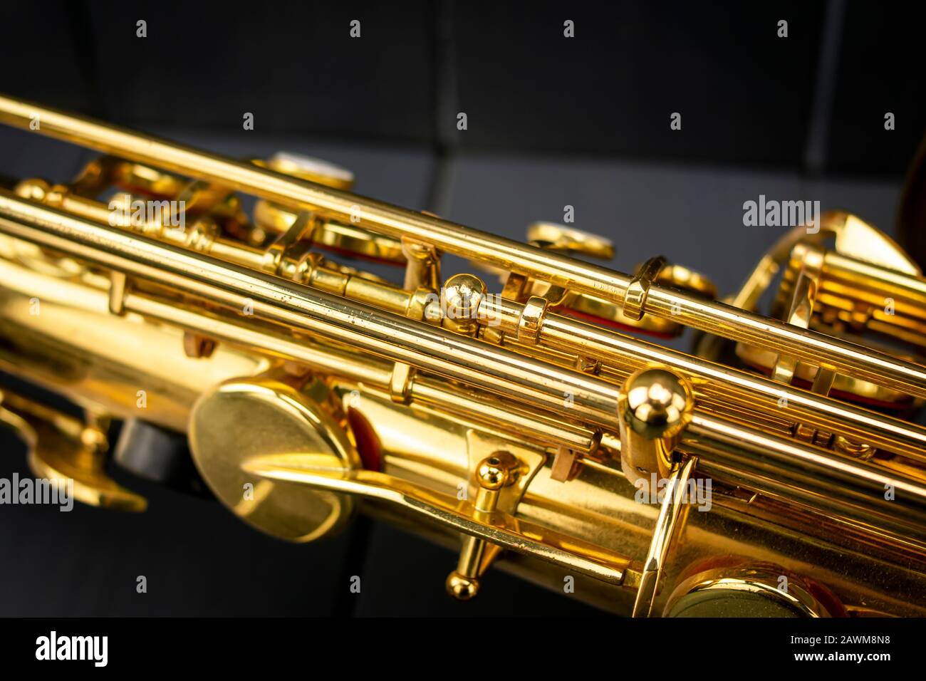 Body, rods and keys of a golden saxophone on gray wooden background Stock Photo