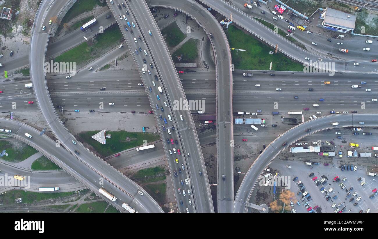 Top Down View Overpass Road Day Traffic in Kiev. Aerial Shot of Highway with Cars and Trucks. Drone Flight over Ukraine Capital Two Level Junction. Big City Sight Stock Photo