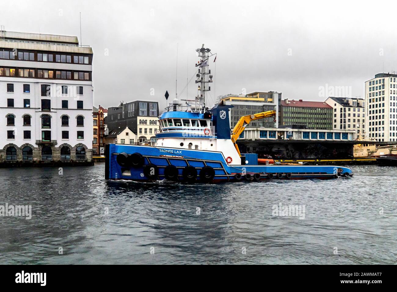 Tug boat Tronds Lax arriving in the port of Bergen, Norway. A dark, rainy and foggy winter day Stock Photo