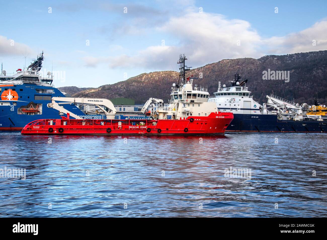 Offshore supply AHTS vessel BB Ocean arriving the port of Bergen, Norway. Meeting a much larger offshore supply vessels, the Horizon Arctic and Island Stock Photo