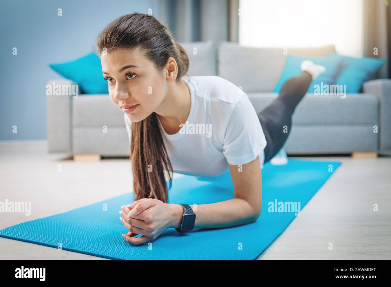 A Enthusiastic Slim Beauty Making Stretching Exercises Stock Photo