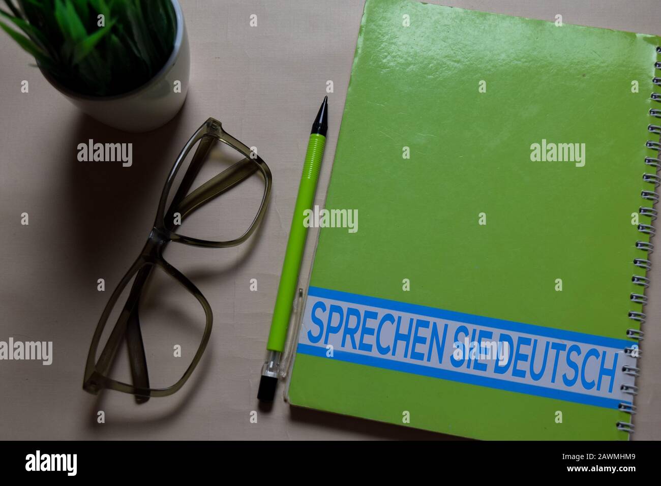 Sprechen Sie Deutsch write on a book isolated on Office Desk. German language it means do you