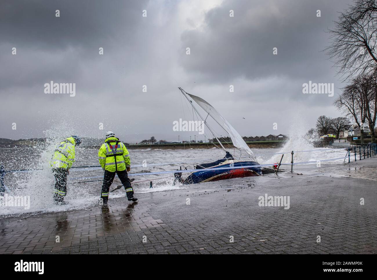 Yacht washed ashore and grounded during Storm Ciara at Cardwell Bay, Gourock, UK with  H M Coastguard in attendance Stock Photo