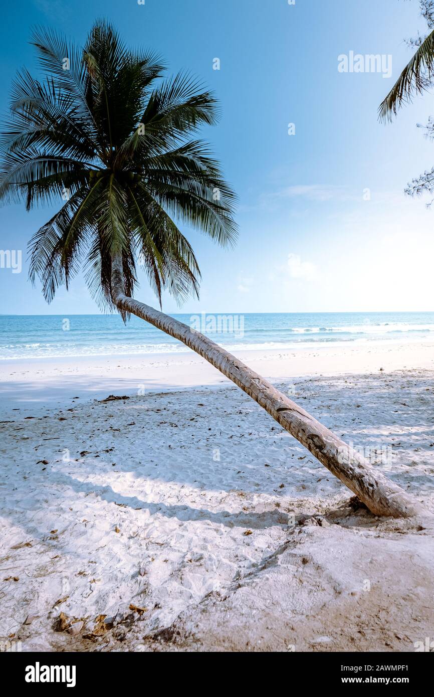Thung Wua Laen beach Chumphon Thailand, couple on the beach by palm tree hanging on the white beach  Stock Photo