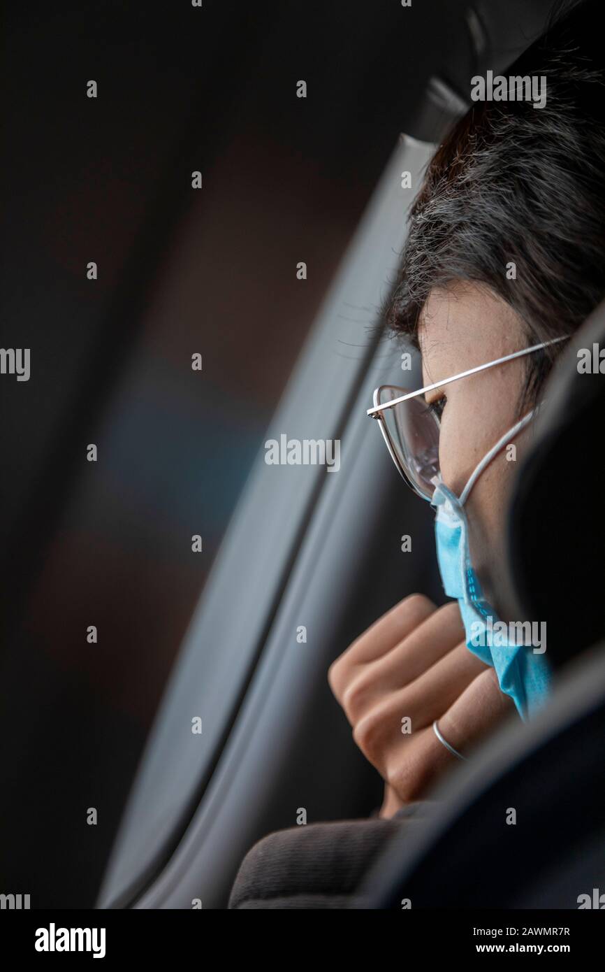 Dallas, Texas - An international traveler from Mexico wears a face mask while looking out the window of an American Airlines flight approaching Dallas Stock Photo