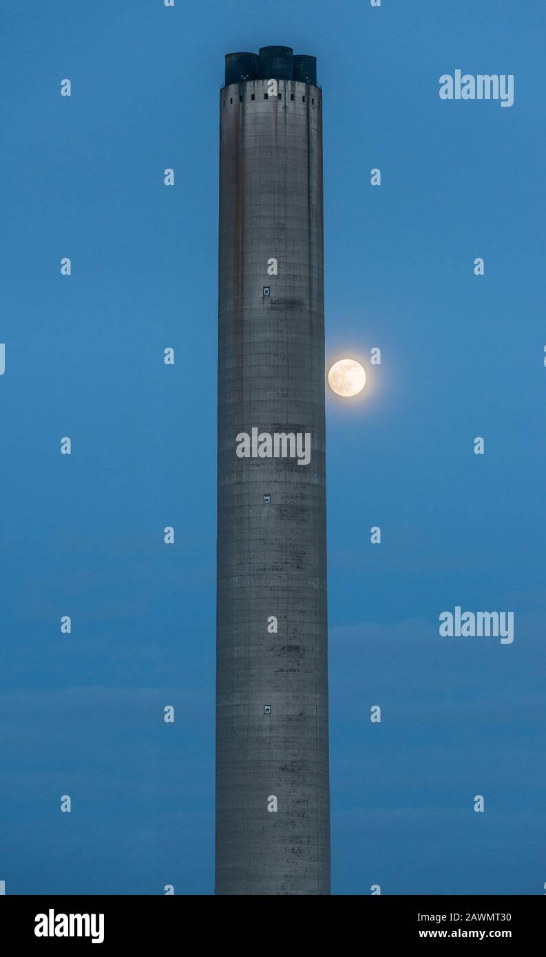 A full moon rises by the 200m chimney at Didcot Power Station, one of