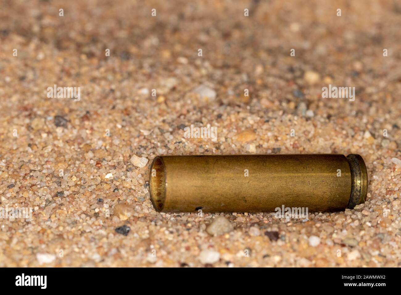 Copper empty gun casing in dry sand Stock Photo Alamy