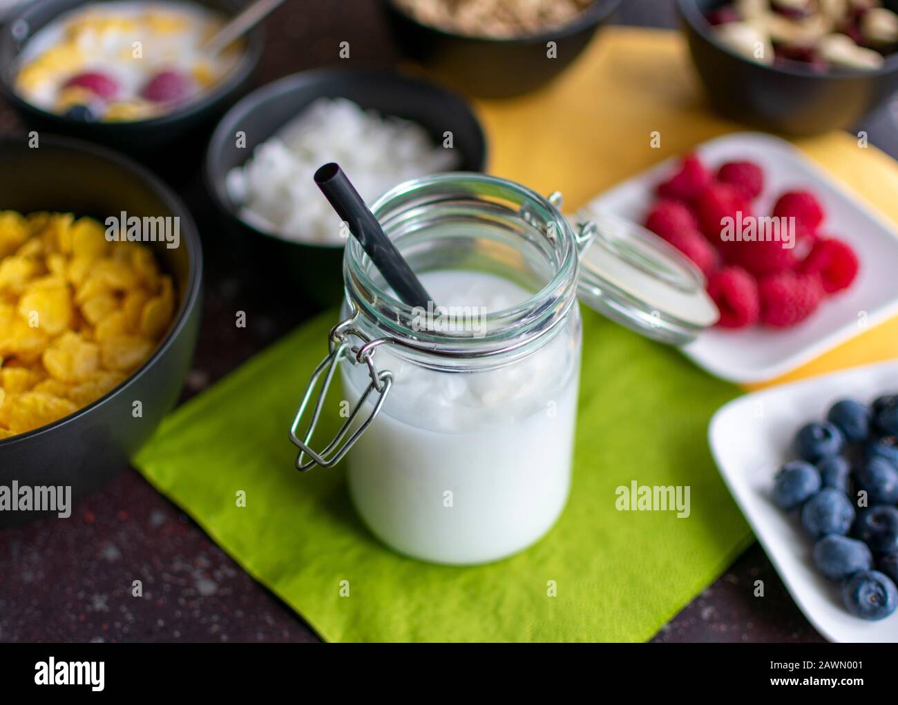 delicious coconut milk with coconut flakes in preserving jar with straw