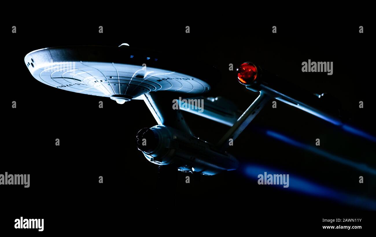 A model of the Starship Enterprise from the TV series Star Trek dramatically lit from below against a black background to replicate space. Stock Photo