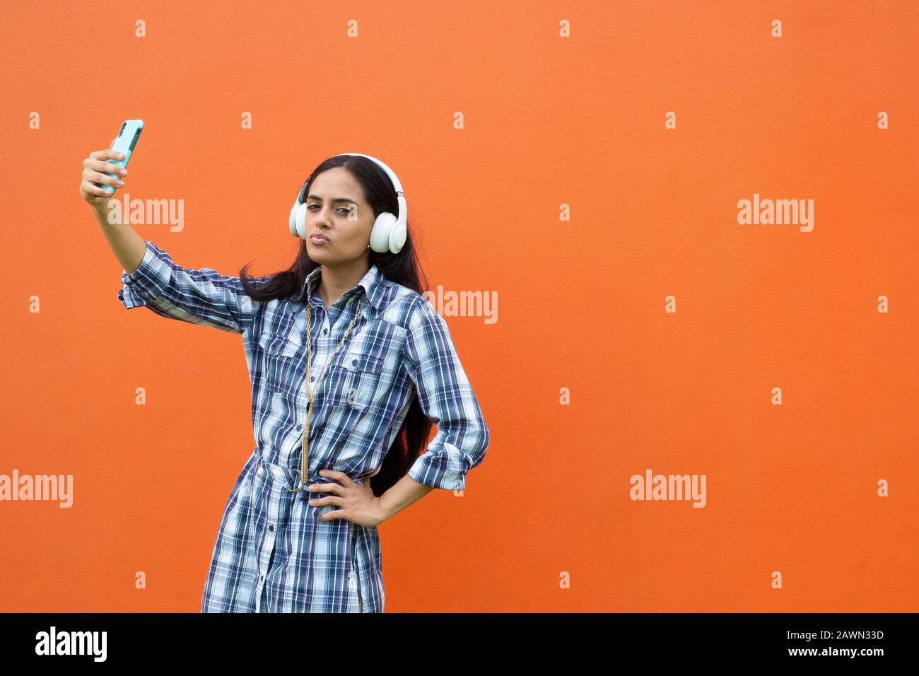 Young latin woman making selfies and listening to music, Panama, Central America Stock Photo
