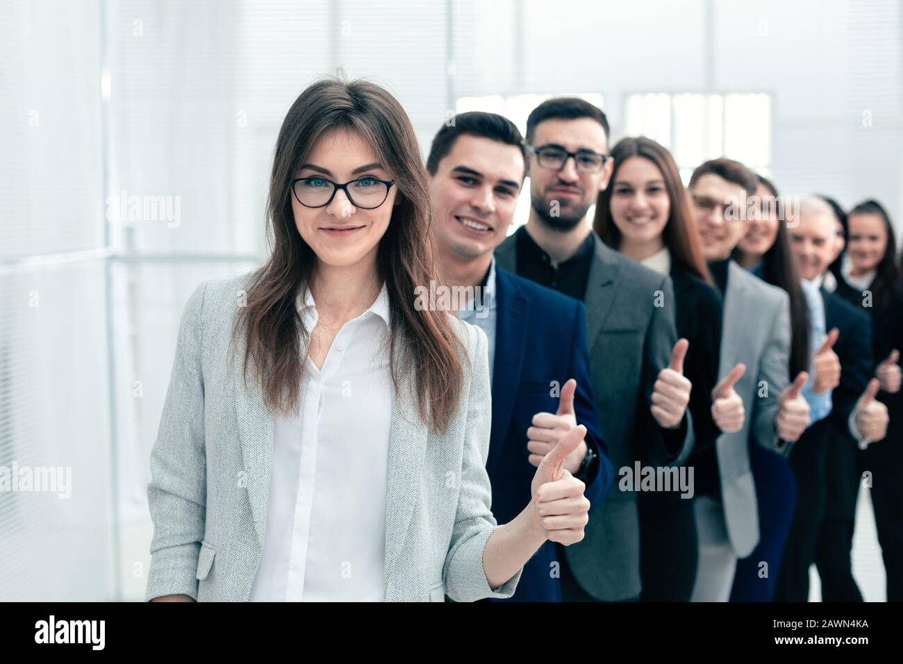 group of young business people showing thumbs up Stock Photo - Alamy