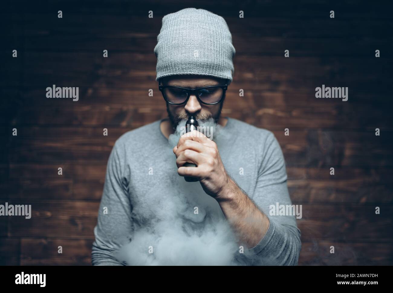 Vaping flavored e-liquid from an electronic cigarette Stock Photo